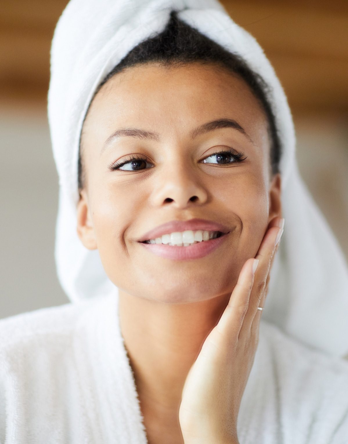 a person wearing a hat and smiling at the camera
